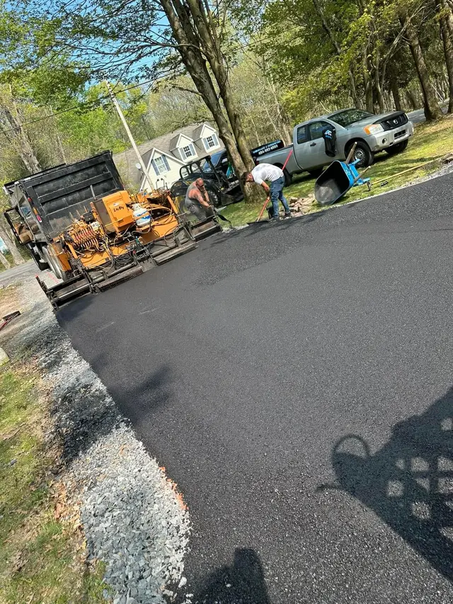 Driveway Pros crew and paving machine on site