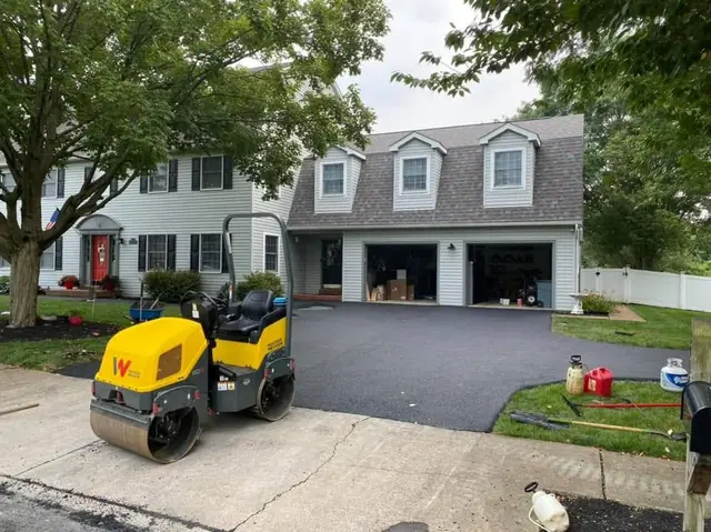 Roller compacting a residential driveway