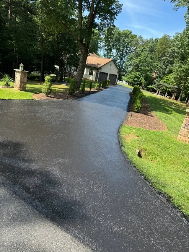 Curved new asphalt residential driveway